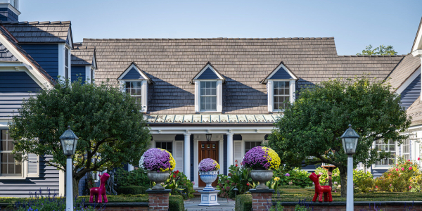 Image of a beautiful house with a lush garden and new roof